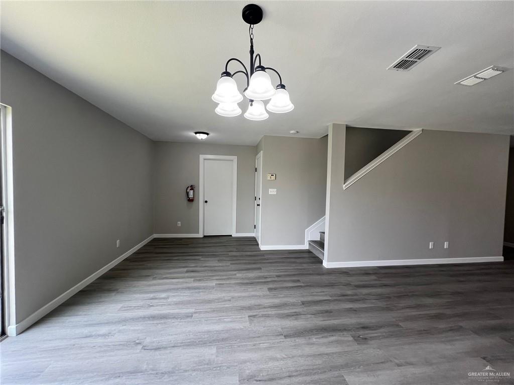 2912 Ozark Avenue McAllen, TX 78504 - Photo 9 of 21 a view of an empty room with wooden floor and windows