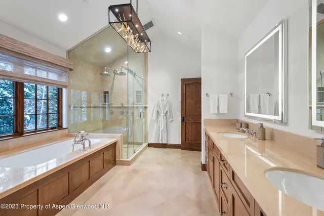a large spacious bathroom with a large tub shower and sink