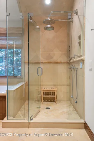 a bathroom with a glass shower door