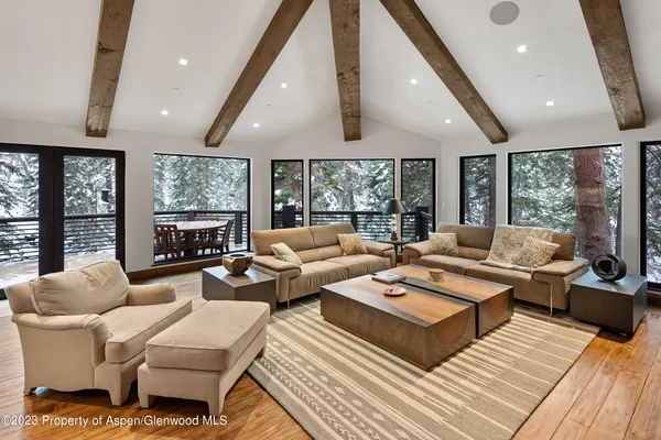 a living room with furniture fireplace and large window