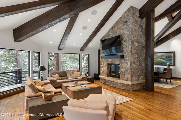a living room with fireplace furniture and a flat screen tv