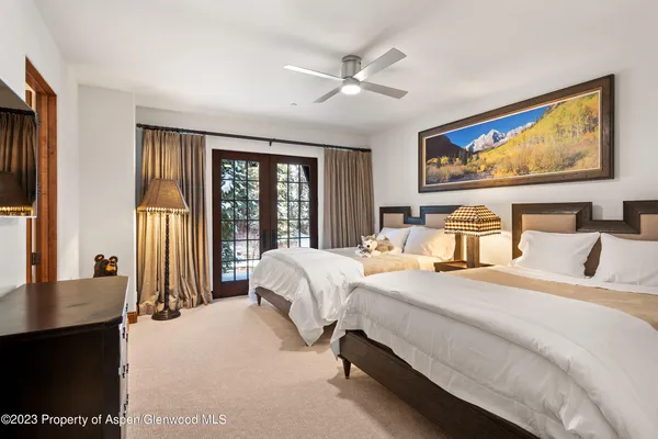a bathroom with a tub a sink and mirror