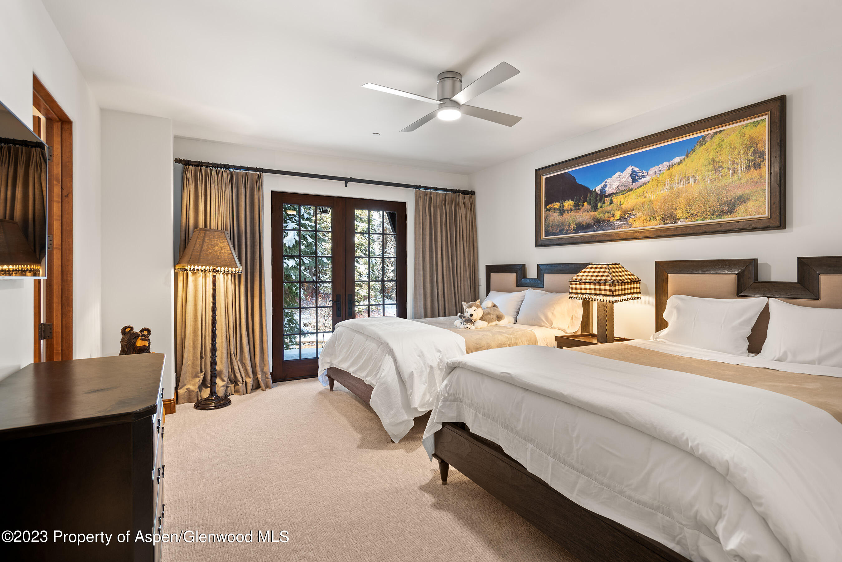 1819 Maroon Creek Road Aspen, CO 81611 - Photo 32 of 43 a bedroom with a large bed and a large window