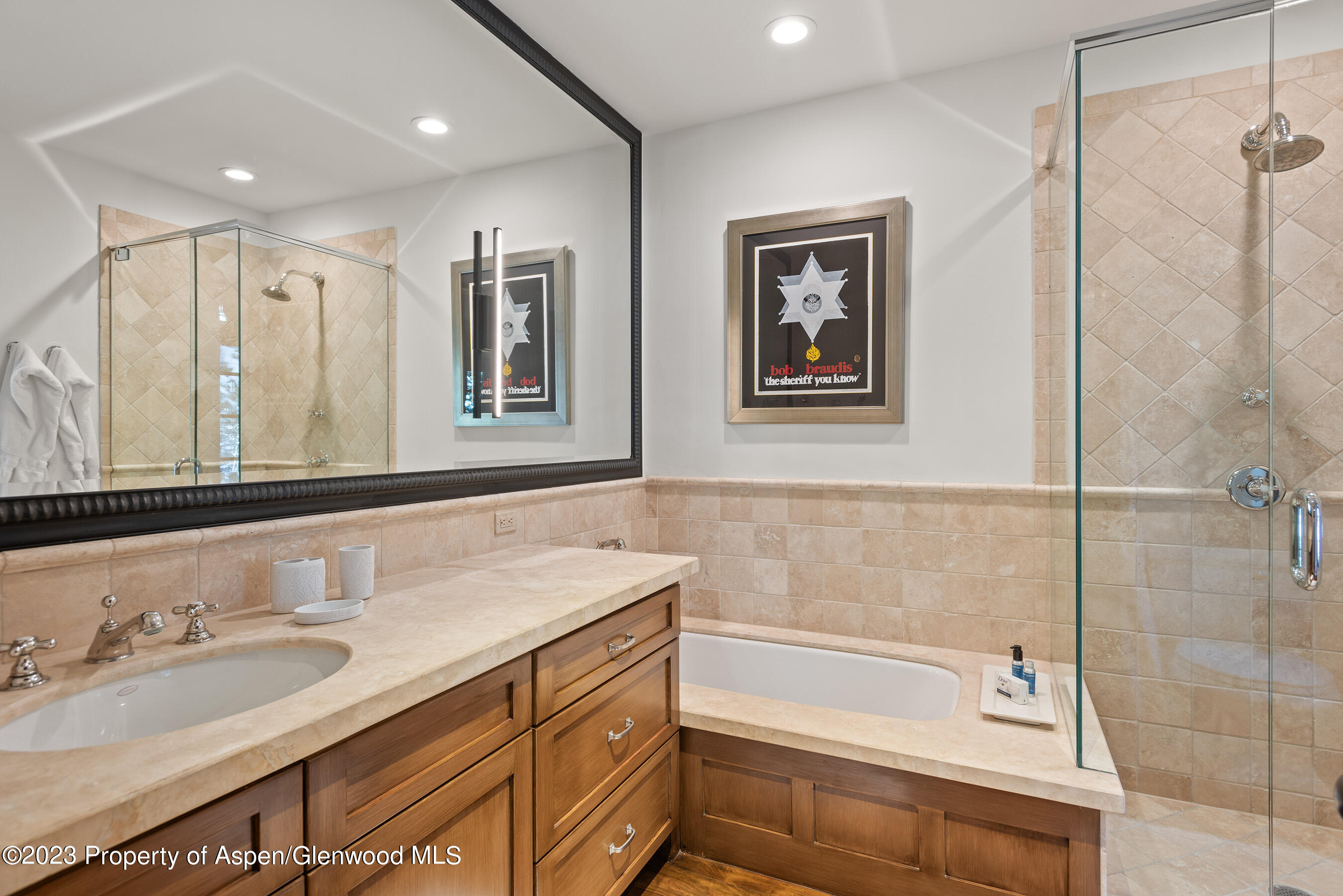 1819 Maroon Creek Road Aspen, CO 81611 - Photo 33 of 43 a bathroom with a tub a sink and mirror