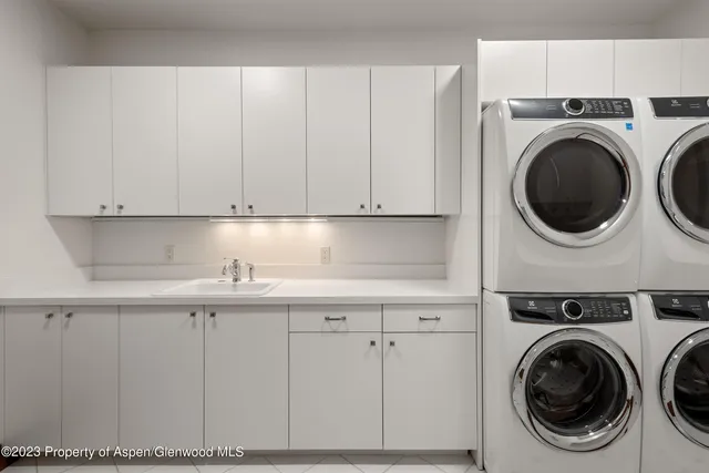 a view of a house with a yard covered in snow