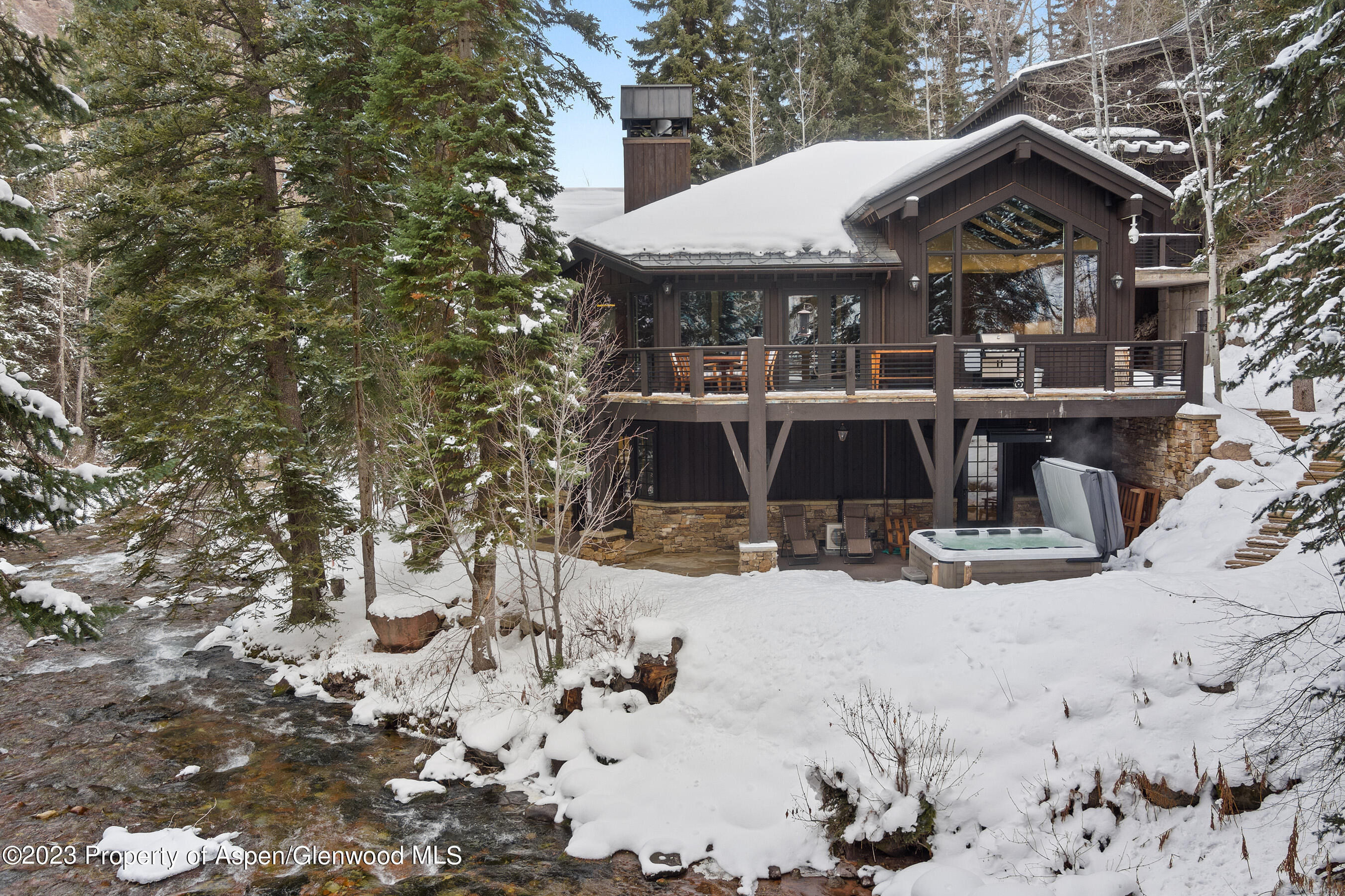 1819 Maroon Creek Road Aspen, CO 81611 - Photo 37 of 43 a view of a house with a yard covered in snow