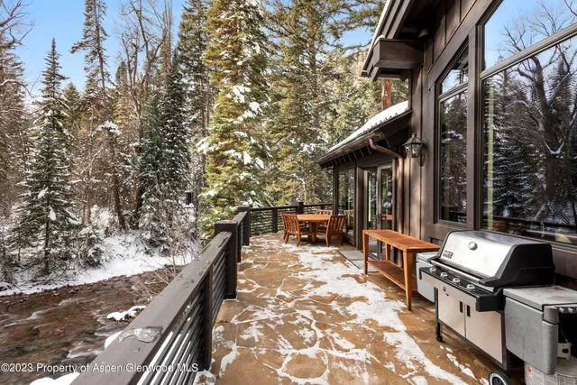a view of balcony with wooden floor and fence