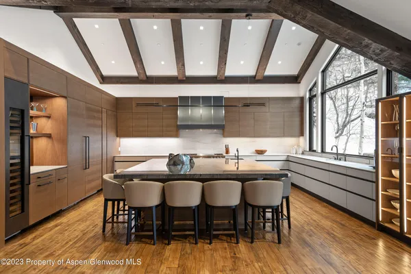 a kitchen with a sink and wooden floor