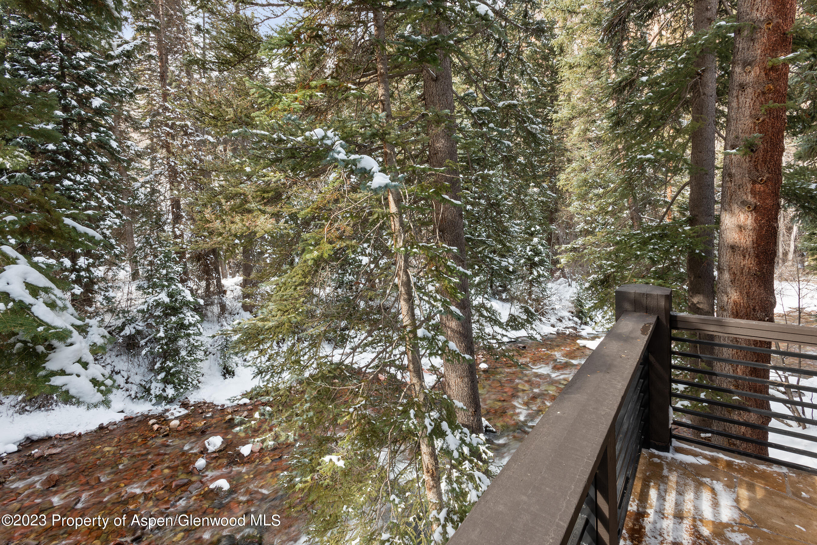 1819 Maroon Creek Road Aspen, CO 81611 - Photo 42 of 43 a view of balcony with wooden floor and fence
