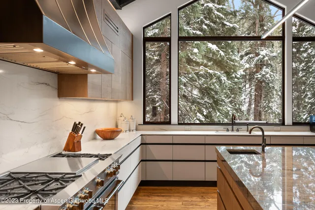a view of a kitchen with a large window and a sink