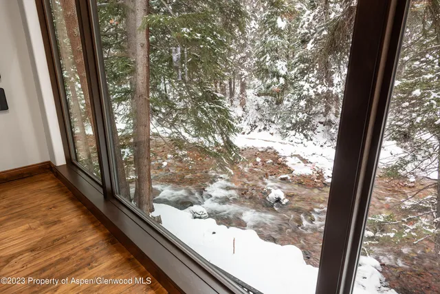 a view of a balcony with wooden floor and fence