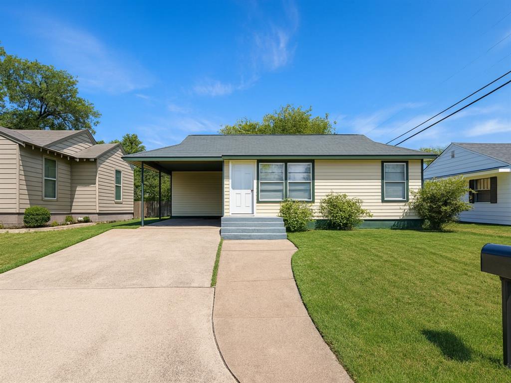 Enhanced** View of front of property with driveway, an attached carport, and a front lawn