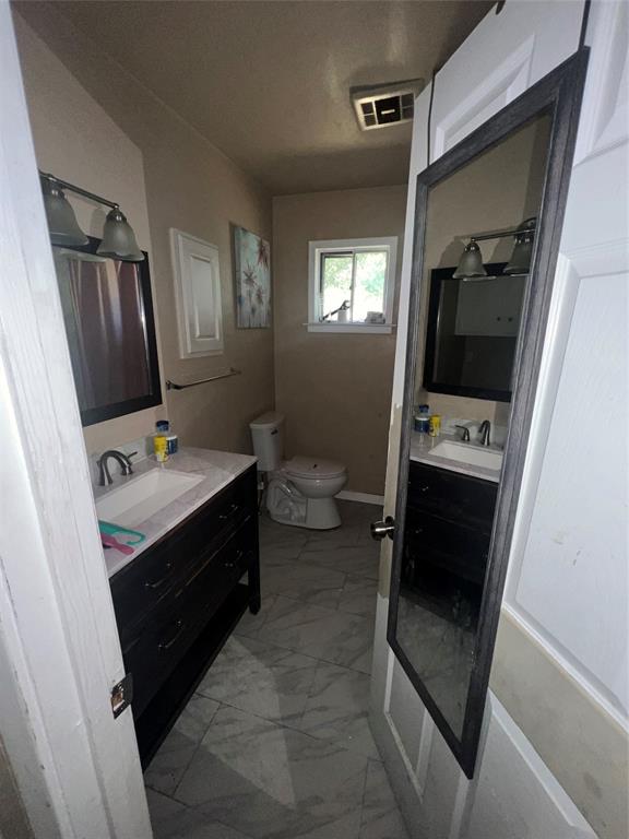 9104 Farmers Road White Settlement, TX 76108 - Photo 15 of 40 Bathroom with vanity and light marble finish flooring