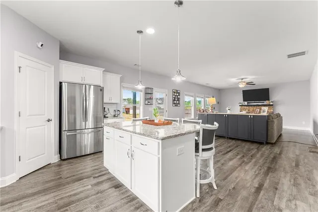 a kitchen with kitchen island a sink a counter top space stainless steel appliances and cabinets