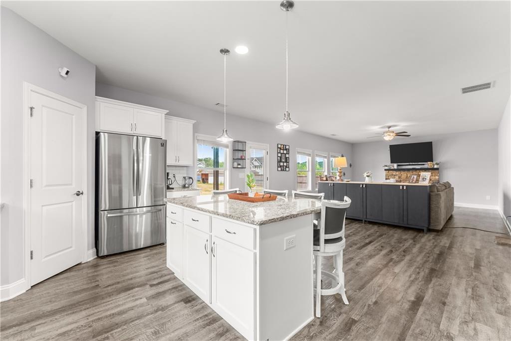 6401 Vista Point Lula, GA 30554 - Photo 15 of 58 a kitchen with kitchen island a sink a counter top space stainless steel appliances and cabinets