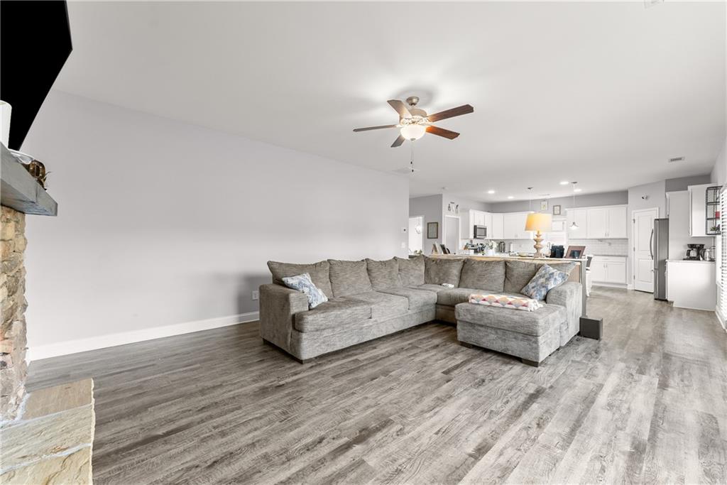 6401 Vista Point Lula, GA 30554 - Photo 19 of 58 a living room with couches and kitchen view with wooden floor