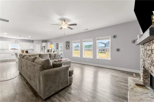 a living room with fireplace furniture and a window