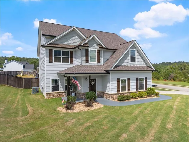 a front view of a house with a yard table and chairs