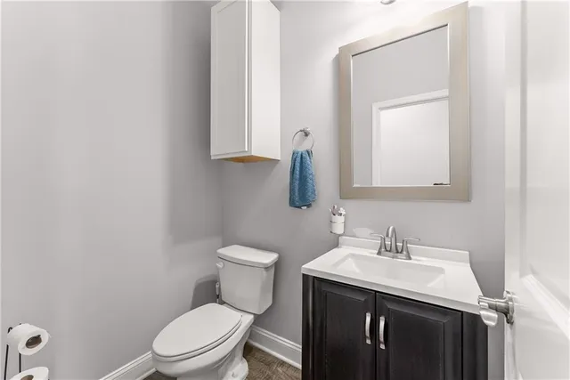 a white toilet sitting next to a bathroom sink