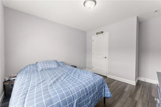 a bedroom with a bed and a desk