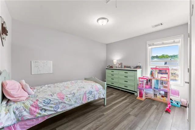 a bedroom with a bed window and a desk