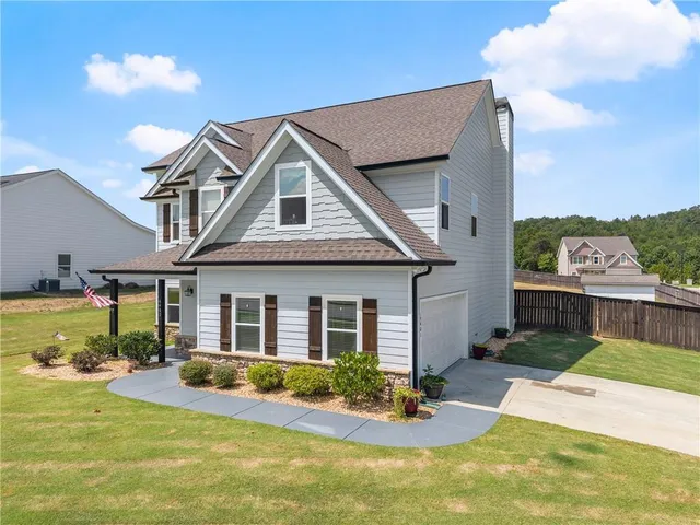 a front view of a house with swimming pool having outdoor seating