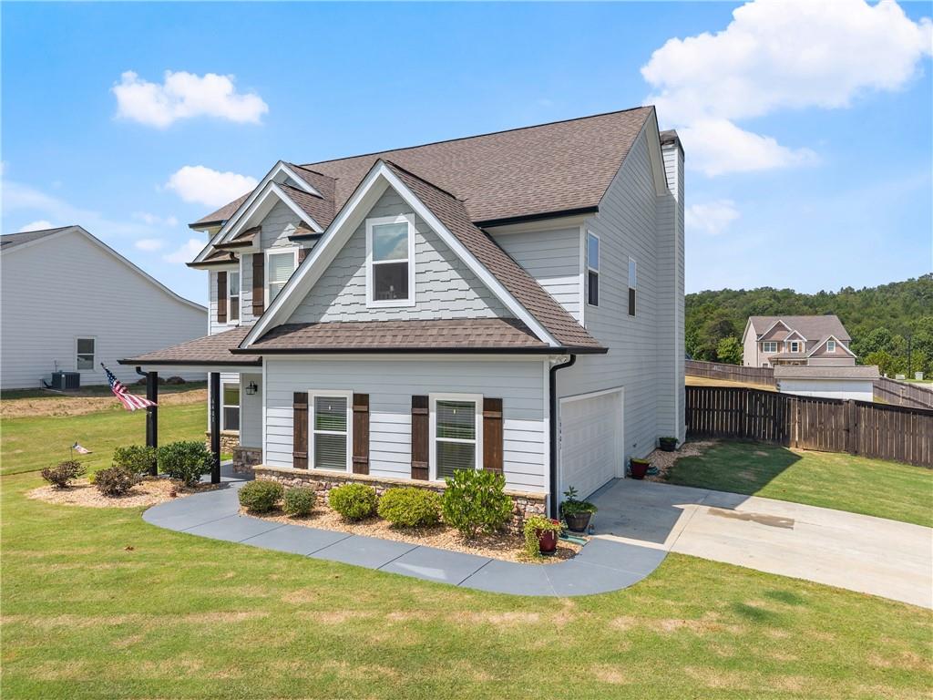6401 Vista Point Lula, GA 30554 - Photo 3 of 58 a front view of a house with swimming pool having outdoor seating