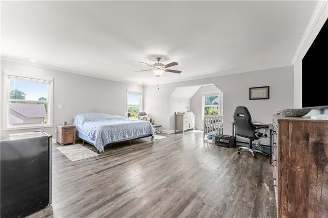 a spacious bedroom with a large bed and a flat screen tv