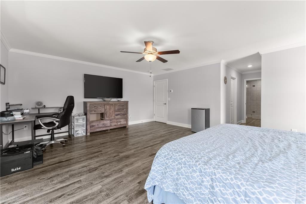 6401 Vista Point Lula, GA 30554 - Photo 32 of 58 a bedroom with a bed and a chandelier