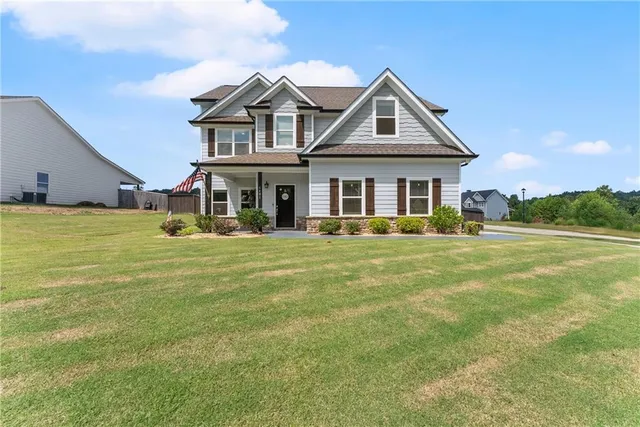 a front view of a house with a yard