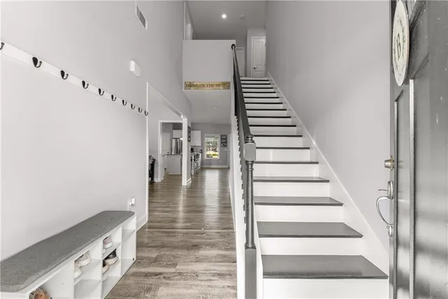 a view of entryway and hall with wooden floor