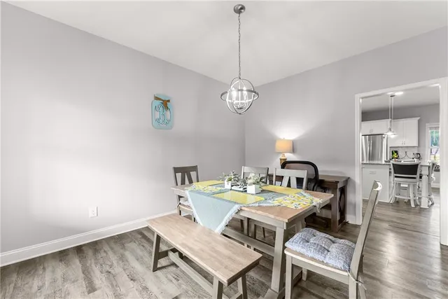a view of a dining room with a table and chairs