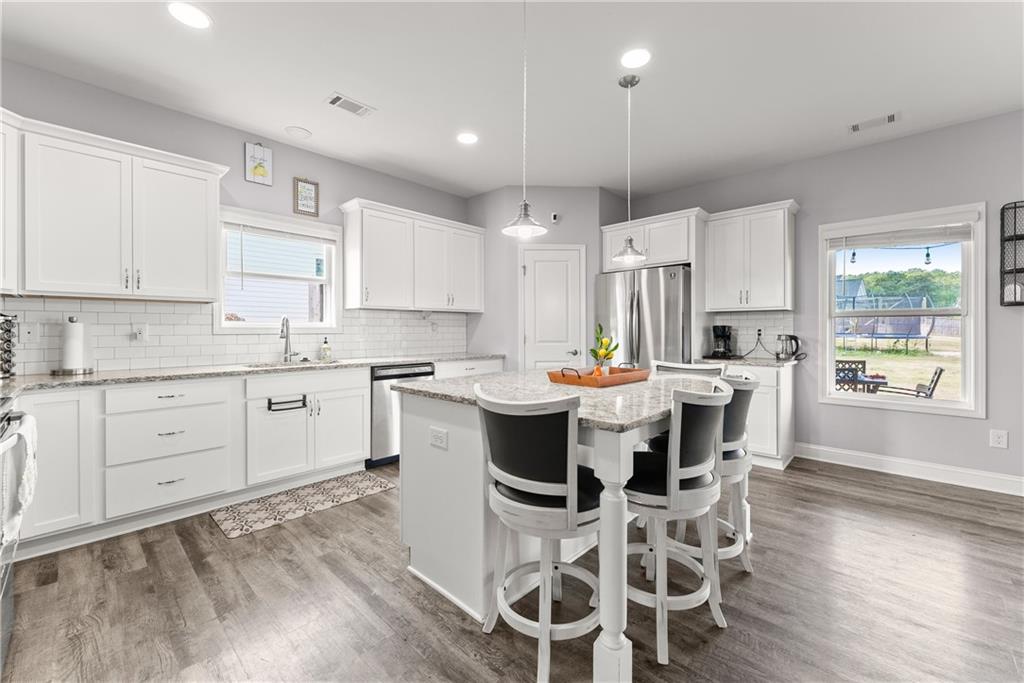 6401 Vista Point Lula, GA 30554 - Photo 10 of 58 a kitchen with a table chairs refrigerator and cabinets