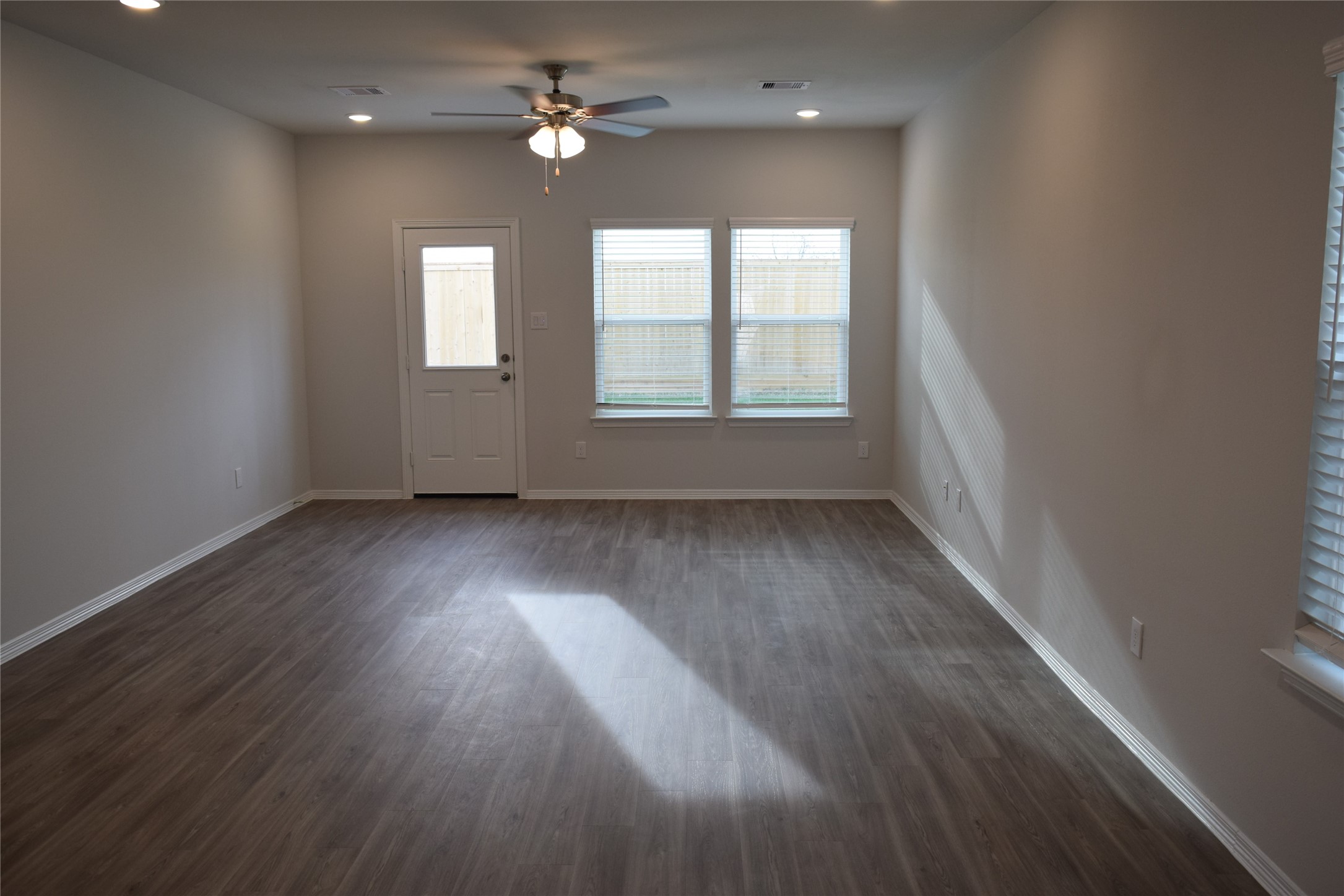 5835 Fresh View Court Katy, TX 77493 - Photo 6 of 21 an empty room with wooden floor and windows