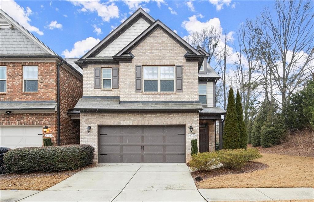 8775 Village Place Suwanee, GA 30024 - Photo 1 of 1 a front view of a house with a garden
