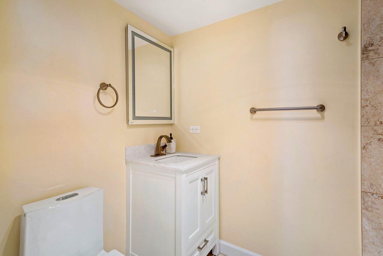 1200 Marine Way, Unit 915 (PH7) North Palm Beach, FL 33408 - Photo 15 of 29 a bathroom with a sink a toilet and a mirror