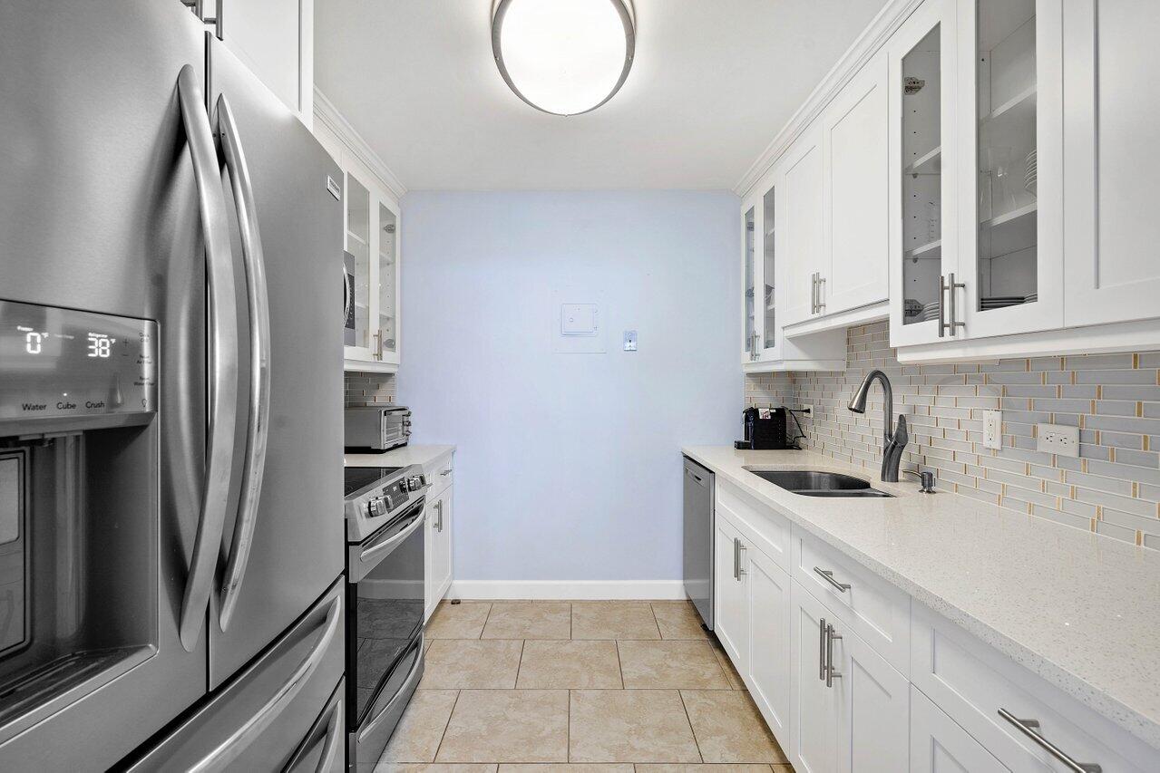 1200 Marine Way, Unit 915 (PH7) North Palm Beach, FL 33408 - Photo 8 of 29 a kitchen with stainless steel appliances granite countertop a refrigerator sink and stove
