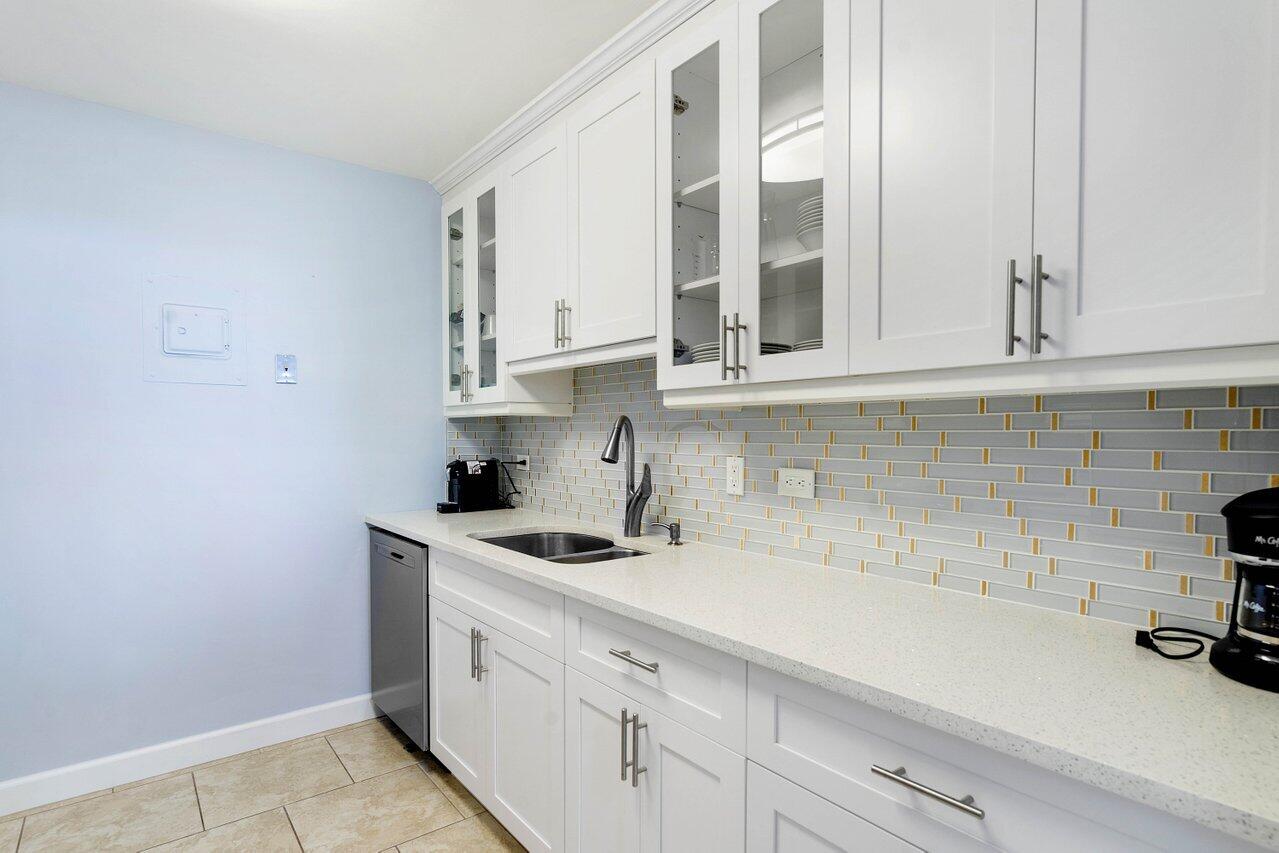 1200 Marine Way, Unit 915 (PH7) North Palm Beach, FL 33408 - Photo 9 of 29 a kitchen with stainless steel appliances granite countertop white cabinets and a counter space