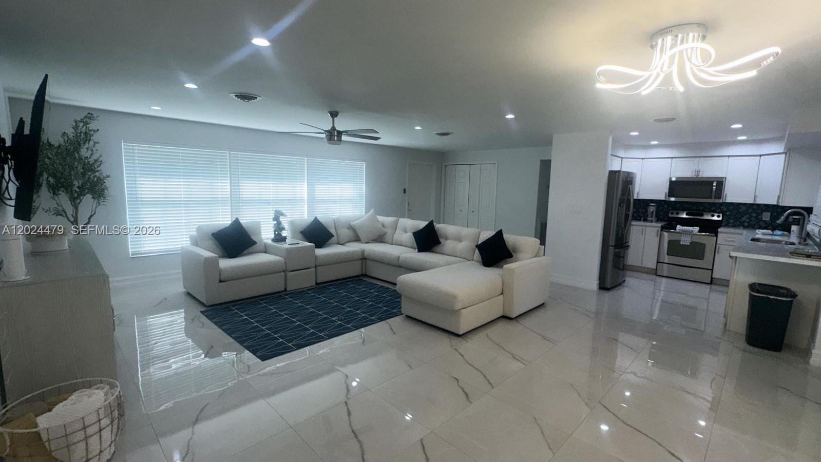 2212 Club House Road North Fort Myers, FL 33917 - Photo 10 of 40 a living room with furniture and a chandelier