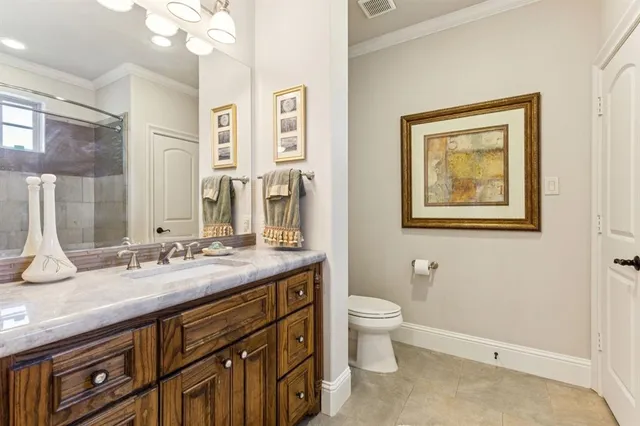 a bathroom with a granite countertop sink mirror and toilet