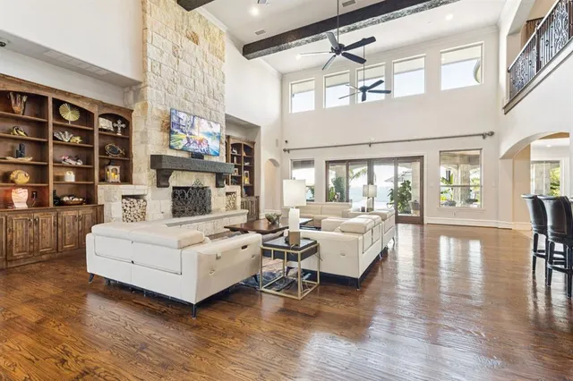 a living room with furniture a fireplace and a chandelier