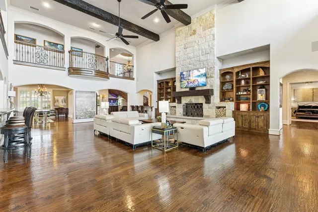 a living room with fireplace furniture and a wooden floor