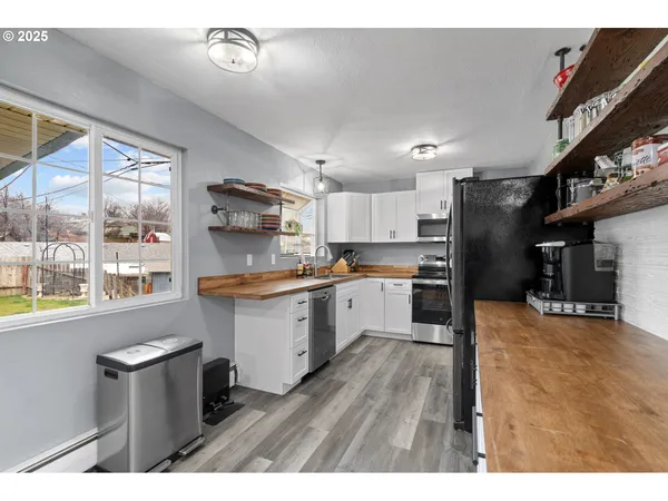 a kitchen with stainless steel appliances granite countertop a sink and cabinets