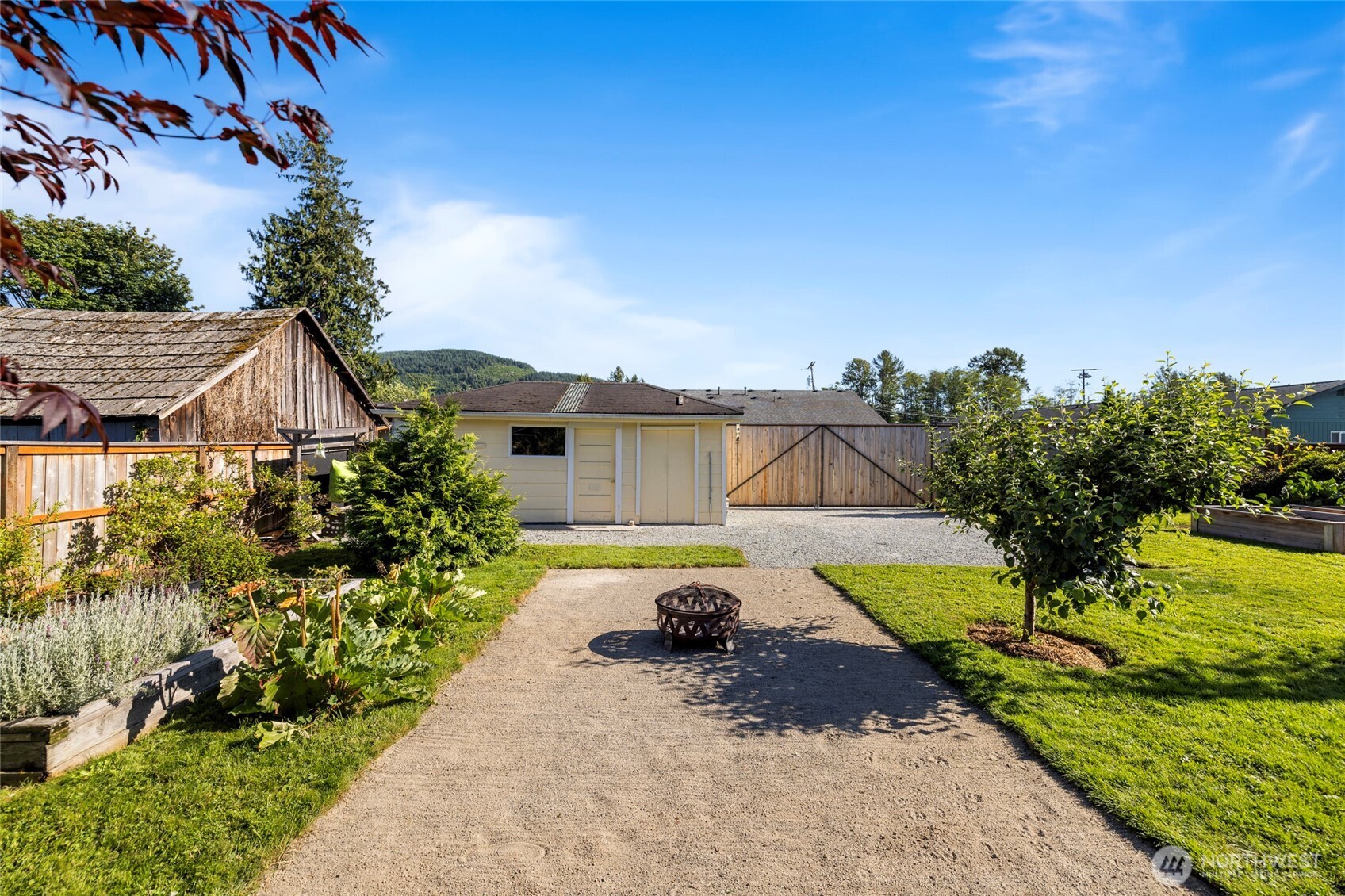 415 Sterling Street Sedro-Woolley, WA 98284 - Photo 29 of 38 a view of a house with a small yard and a large tree