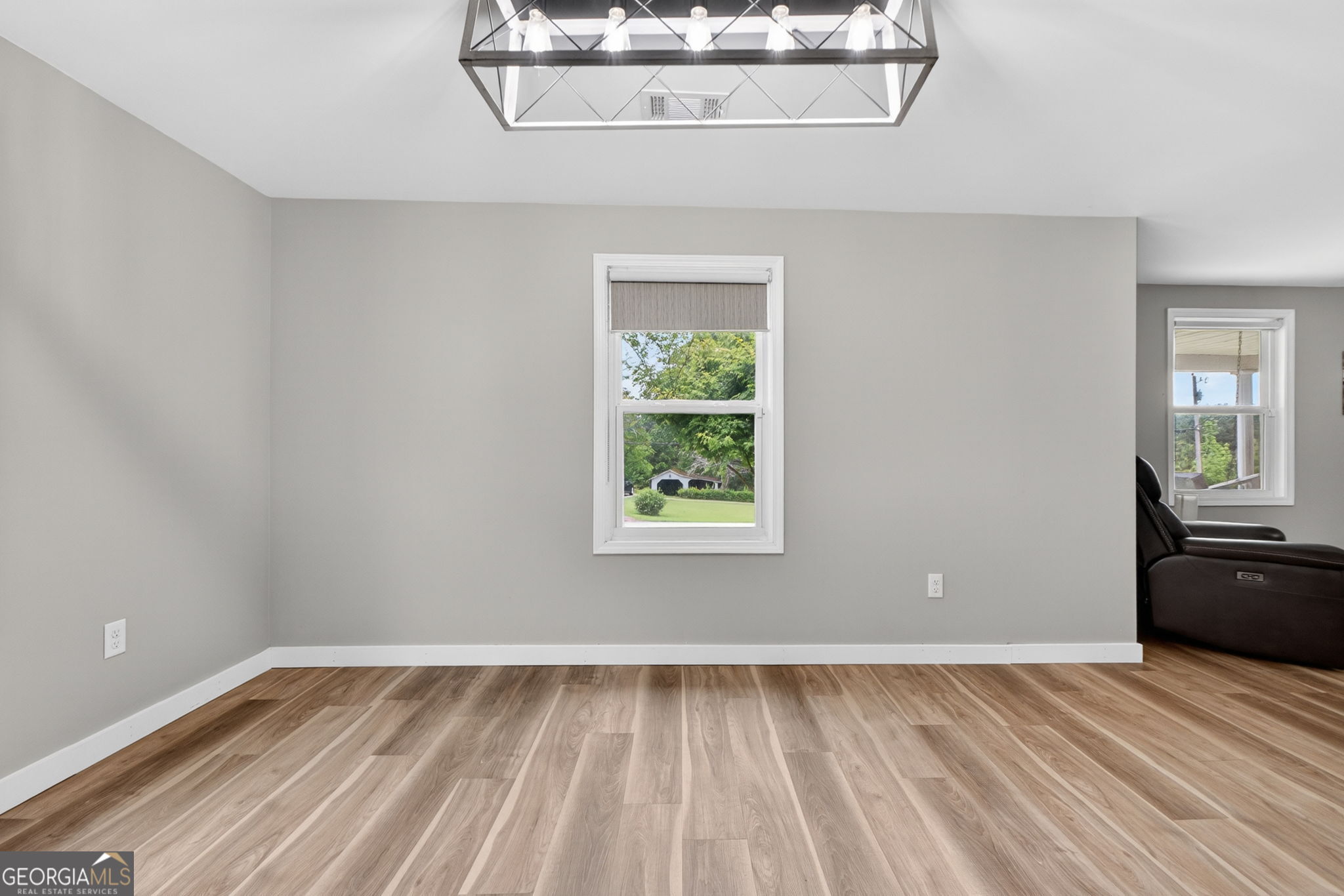 1199 Youngs Mill Road LaGrange, GA 30241 - Photo 11 of 33 a view of an empty room with wooden floor and a window
