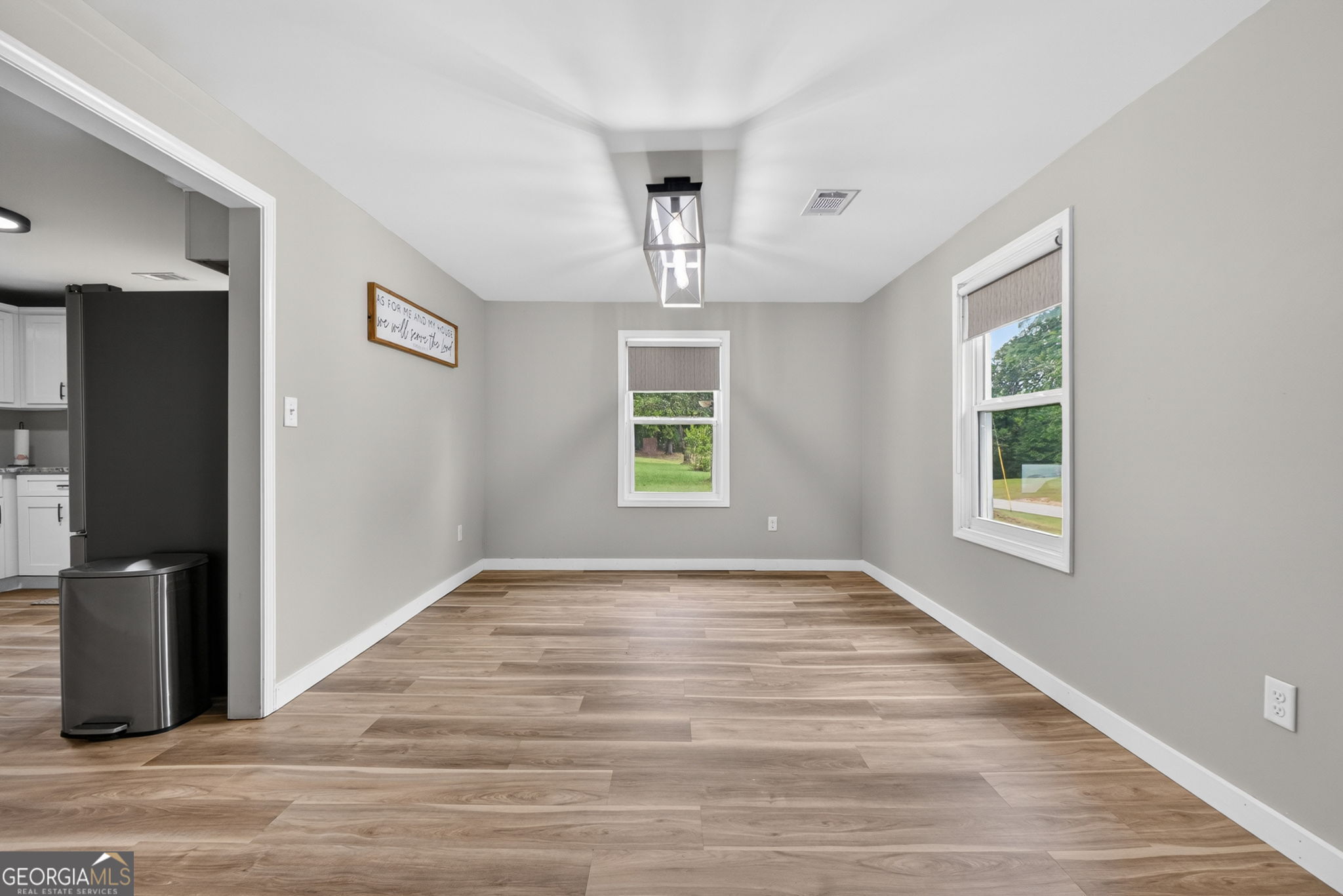 1199 Youngs Mill Road LaGrange, GA 30241 - Photo 10 of 33 a view of an empty room with wooden floor and a window
