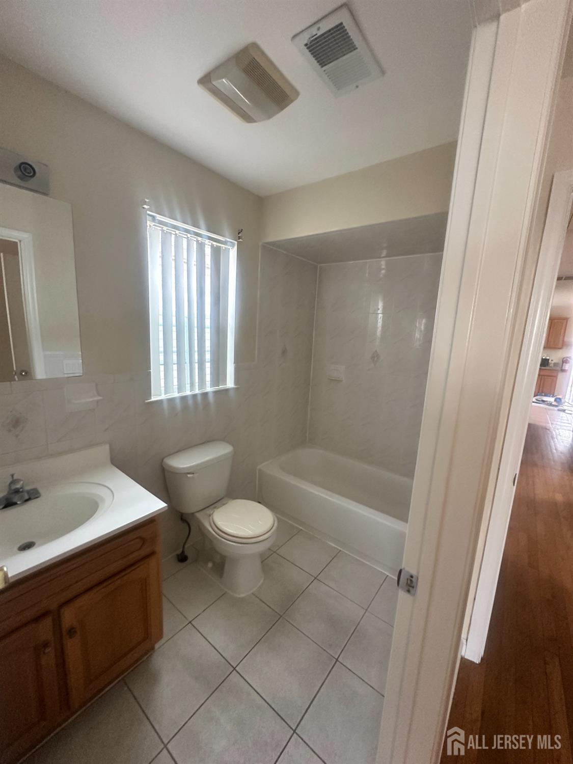 663 South Park Street Elizabeth, NJ 07206 - Photo 7 of 11 a bathroom with a sink a toilet and shower