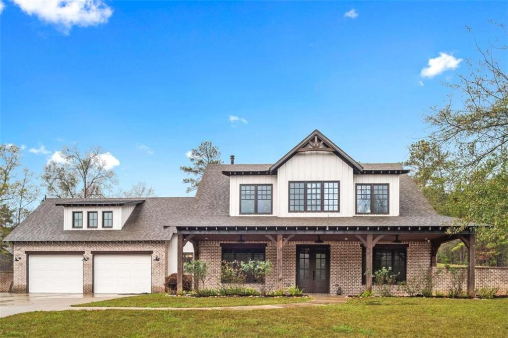 438 Turner Bridge Road Barnesville, GA 30204 - Photo 1 of 1 a front view of a house with a garden and plants