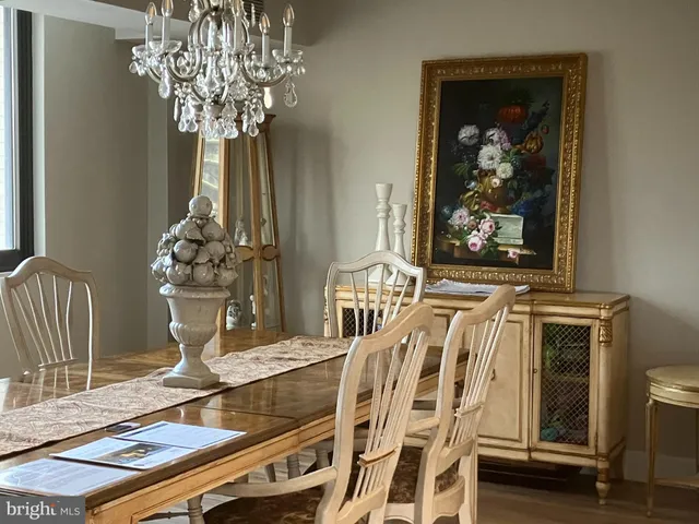 a view of a dining room with furniture wooden floor and chandelier