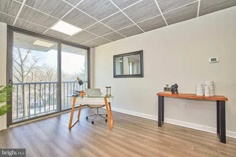 a work room with furniture and wooden floor